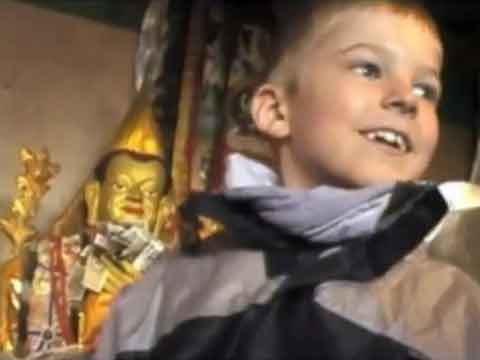 
Young son inside monastery with Buddhist statues - Tibet An Adventure With Our Children Youtube Video by Ed van der Kooy and Piet Warffemius
